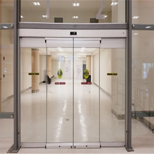 How do automatic sliding door operators contribute to energy efficiency in buildings?