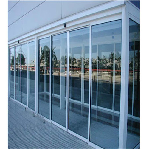 How do automatic sliding door openers contribute to accessibility and comply with accessibility standards in public buildings?