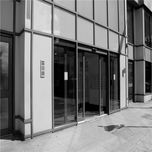 What is an automatic sliding door controller, and how does it function?